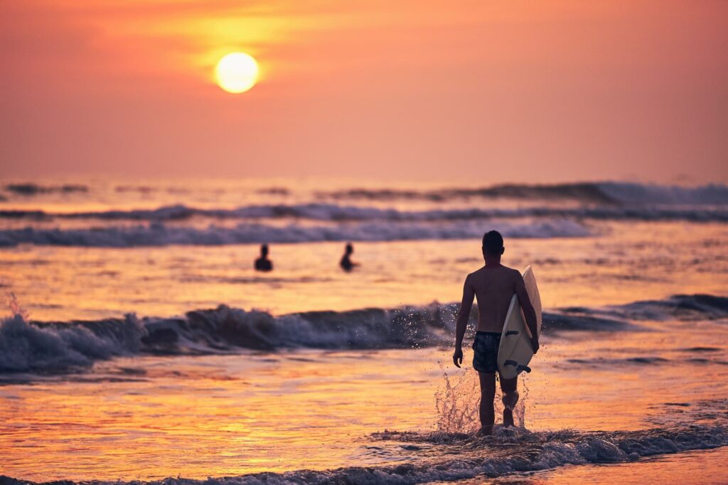Surfer at sunset Kuta Beach